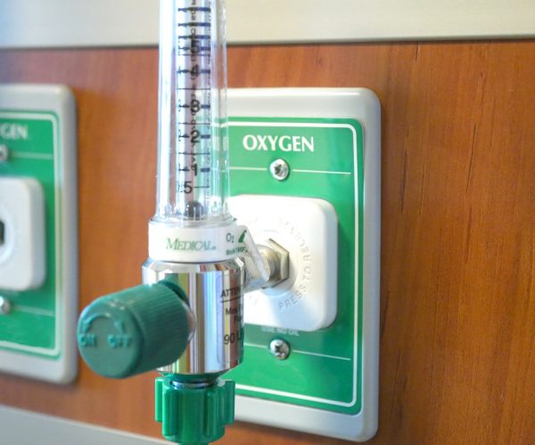 Close up of medical oxygen gas valve in a hospital room.