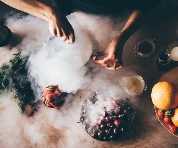 Woman making ice cream with liquid nitrogen.